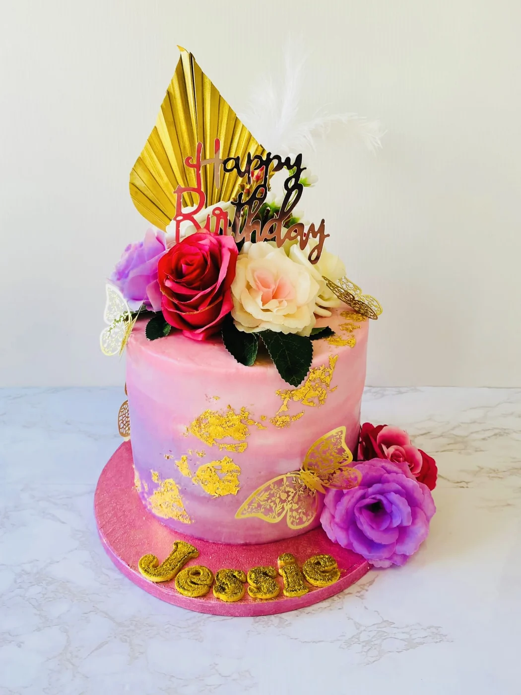 Pink and gold cake with handmade floral decoration